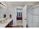Bright bathroom with double sink vanity, white quartz countertops, and a glass door shower stall at 7372 Oakview Dr, Avon, IN 46123