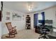 Well lit bedroom with neutral carpet and a rocking chair, with a desk and shelving unit at 7372 Oakview Dr, Avon, IN 46123