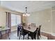Cozy dining room boasting a stylish chandelier, dark wood table and six chairs at 7372 Oakview Dr, Avon, IN 46123