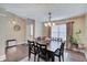 Bright dining room with modern lighting, rich wood floors, and seating for six guests at 7372 Oakview Dr, Avon, IN 46123