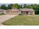 Charming brick home featuring a three-car garage and a well-manicured front lawn at 7372 Oakview Dr, Avon, IN 46123