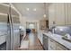 Modern kitchen showcasing stainless steel appliances and views to the open-concept living area at 7372 Oakview Dr, Avon, IN 46123