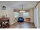 Cozy room featuring hardwood floors, a blue chair and a decorative hanging light fixture at 7372 Oakview Dr, Avon, IN 46123
