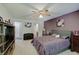 Angle shot of spacious main bedroom with ensuite bathroom access, featuring purple walls and neutral carpet at 7372 Oakview Dr, Avon, IN 46123