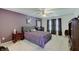 Spacious main bedroom featuring purple walls and bedding, plus a ceiling fan for added comfort at 7372 Oakview Dr, Avon, IN 46123