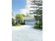 Charming home featuring a light blue garage door and a tree in the front yard at 7470 Charrington Ct, Indianapolis, IN 46254