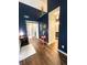 Open hallway featuring hard wood floors, high ceilings, and convenient access to the bathroom at 7470 Charrington Ct, Indianapolis, IN 46254
