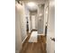 Clean hallway featuring wood floors, neutral walls, and access to other rooms at 7470 Charrington Ct, Indianapolis, IN 46254