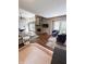 Open-concept living room with fireplace, wood floors, and access to the outdoor space at 7470 Charrington Ct, Indianapolis, IN 46254