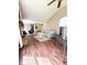 Sun-drenched living room with fireplace, cathedral ceiling, and comfortable striped couch at 7470 Charrington Ct, Indianapolis, IN 46254