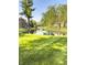 Scenic pond view surrounded by lush green grass, mature trees and single Gathering homes at 7470 Charrington Ct, Indianapolis, IN 46254