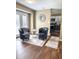 Cozy sitting area with dark hardwood floors and view of an eat-in kitchen at 7470 Charrington Ct, Indianapolis, IN 46254