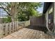 A cozy backyard featuring a quaint brick patio, a weathered wooden fence, and lush greenery, creating a private retreat at 7616 Derrek Pl, Indianapolis, IN 46219