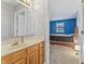 Bathroom featuring a vanity and mirror, with a view into a bedroom at 7616 Derrek Pl, Indianapolis, IN 46219
