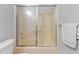 Bright bathroom featuring a tub-shower combo with sliding glass doors at 7616 Derrek Pl, Indianapolis, IN 46219