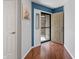 Bright entryway featuring hardwood floors, neutral paint and storm door at 7616 Derrek Pl, Indianapolis, IN 46219