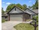 Charming home featuring a two-car garage, beautiful brick accents, and a well-maintained lawn at 7616 Derrek Pl, Indianapolis, IN 46219
