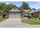 Charming home featuring a two-car garage, beautiful brick accents, and a well-maintained lawn at 7616 Derrek Pl, Indianapolis, IN 46219