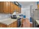Bright kitchen with wood cabinets, stainless steel appliances, hardwood floors, and an open layout at 7616 Derrek Pl, Indianapolis, IN 46219