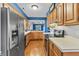Bright kitchen features wood cabinets, stainless steel appliances, white countertops, and hardwood floors at 7616 Derrek Pl, Indianapolis, IN 46219