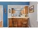 Eat-in kitchen with breakfast bar, stainless appliances, and great natural light at 7616 Derrek Pl, Indianapolis, IN 46219