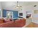 Spacious living room with vaulted ceilings, comfortable seating, and view to a bedroom at 7616 Derrek Pl, Indianapolis, IN 46219