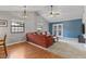 Bright living room featuring hardwood floors, vaulted ceiling and double doors at 7616 Derrek Pl, Indianapolis, IN 46219