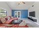 Spacious living room with vaulted ceilings, comfortable seating, and access to outdoor space at 7616 Derrek Pl, Indianapolis, IN 46219