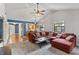 Inviting living room boasts vaulted ceilings, fan, updated windows, and stylish modern furniture at 7616 Derrek Pl, Indianapolis, IN 46219