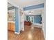 Bright living room featuring hardwood floors, a fireplace, and a kitchen space at 7616 Derrek Pl, Indianapolis, IN 46219
