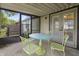 Charming screened patio featuring a round table and chairs, perfect for relaxing and enjoying the outdoors at 7616 Derrek Pl, Indianapolis, IN 46219