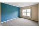 Bedroom featuring a blue accent wall and window providing natural light at 7715 Bolero Dr, Camby, IN 46113