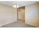 Spacious dining room with gray carpet and chandelier lighting extending towards the foyer at 7715 Bolero Dr, Camby, IN 46113