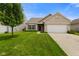 Charming single-story home featuring a well-manicured lawn and attached two-car garage at 7715 Bolero Dr, Camby, IN 46113