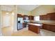 Well-lit kitchen featuring stainless steel appliances and central island with tiled floors at 7715 Bolero Dr, Camby, IN 46113