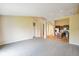 Open-concept living room and kitchen with stainless steel appliances and neutral tones at 7715 Bolero Dr, Camby, IN 46113