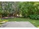 View of concrete backyard patio with lush landscaping and brick structure at 779 Alvey Ct, Greenwood, IN 46143