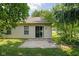 Backyard concrete patio with sliding door, window, and green lawn at 779 Alvey Ct, Greenwood, IN 46143