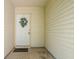 Covered front porch featuring a white front door adorned with a wreath and black door mat at 779 Alvey Ct, Greenwood, IN 46143