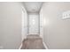 Hallway leading to the front door, featuring a carpeted floor and neutral wall paint at 779 Alvey Ct, Greenwood, IN 46143