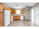 This kitchen features wood cabinets, white appliances and neutral countertops at 779 Alvey Ct, Greenwood, IN 46143