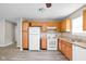 This kitchen features wood cabinets and white appliances at 779 Alvey Ct, Greenwood, IN 46143