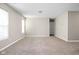 This living room is spacious with carpeted floors, neutral walls and natural light at 779 Alvey Ct, Greenwood, IN 46143