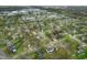 Expansive aerial view of a neighborhood featuring tree-lined streets, community ponds, and single-Gathering homes at 8306 Corkwood Dr, Indianapolis, IN 46227