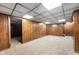 Spacious basement with retro wood paneling and neutral carpet, offering versatile potential at 8306 Corkwood Dr, Indianapolis, IN 46227