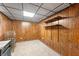 Finished basement space featuring wood paneling and a carpeted floor at 8306 Corkwood Dr, Indianapolis, IN 46227