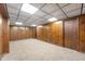 Expansive finished basement with wood paneling and cozy carpeting; perfect for recreation at 8306 Corkwood Dr, Indianapolis, IN 46227