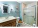 Functional bathroom featuring a glass-enclosed shower, vanity, and updated fixtures at 8306 Corkwood Dr, Indianapolis, IN 46227