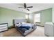 Comfortable bedroom featuring soft green walls, carpet floors, and natural light at 8306 Corkwood Dr, Indianapolis, IN 46227