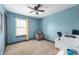 Sunlit bedroom features a comfortable chair, ceiling fan, and ample space at 8306 Corkwood Dr, Indianapolis, IN 46227